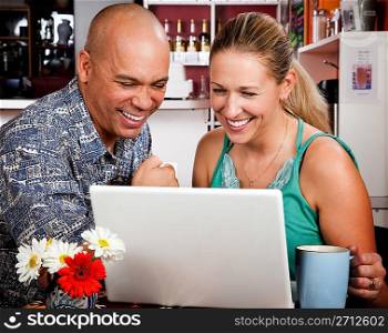 Couple in Coffee House with Laptop Computer