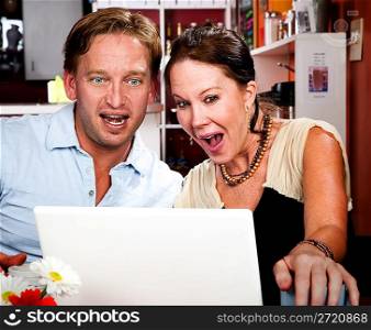 Couple in Coffee House with Laptop Computer