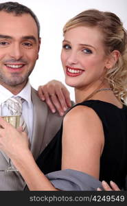 Couple in evening wear drinking champagne