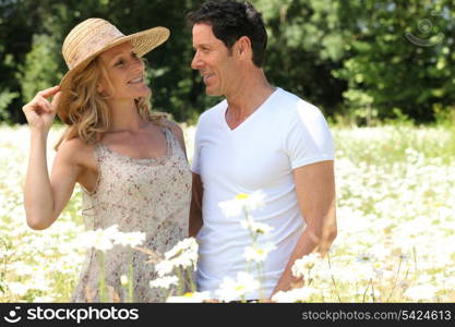 Couple in field of flowers.