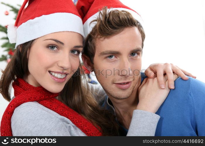 Couple in front of a Christmas tree