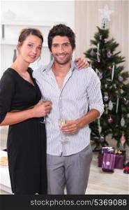 Couple in front of a Christmas tree