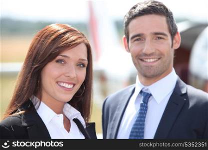 Couple in front of airplane