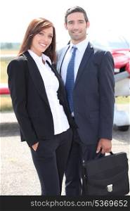 Couple in front of airplane