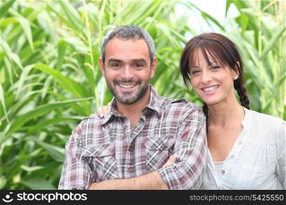 Couple in front of plants