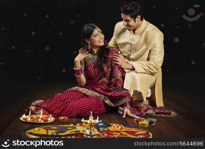 Couple in front of rangoli
