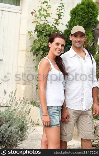 Couple in front of their house