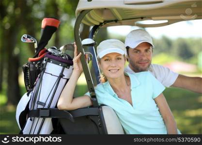 Couple in golf cart