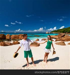 Couple in green having fun on a tropical beach at Seychelles