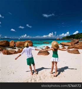 Couple in green having fun on a tropical beach at Seychelles