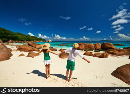 Couple in green having fun on a tropical beach at Seychelles