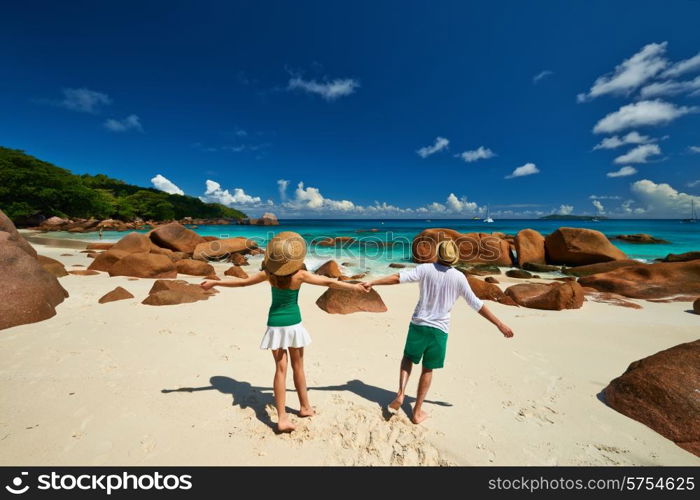 Couple in green having fun on a tropical beach at Seychelles