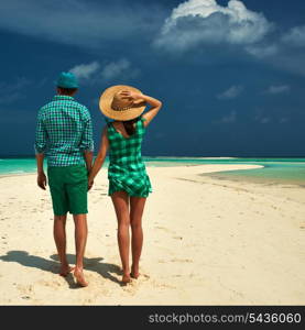 Couple in green on a tropical beach at Maldives