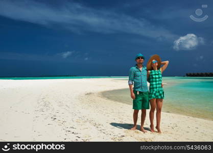 Couple in green on a tropical beach at Maldives