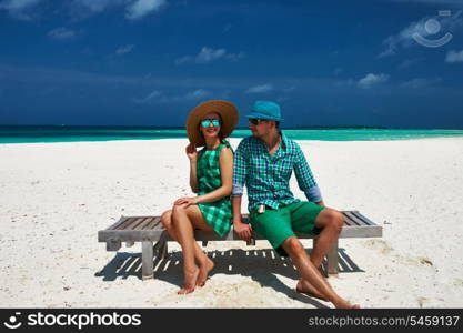 Couple in green on a tropical beach at Maldives