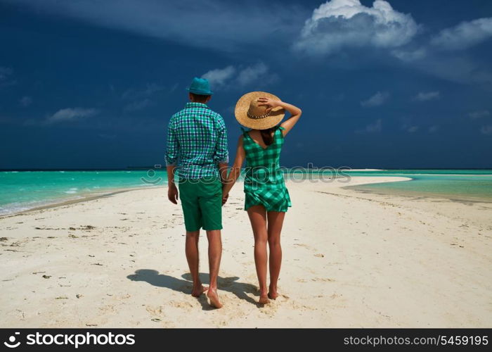 Couple in green on a tropical beach at Maldives