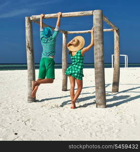 Couple in green on a tropical beach at Maldives