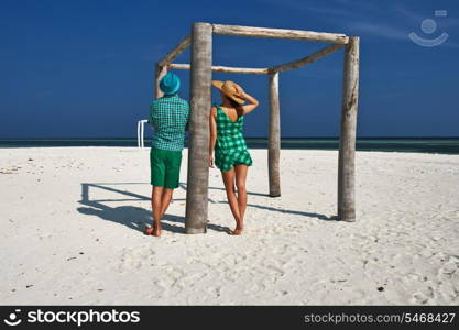 Couple in green on a tropical beach at Maldives