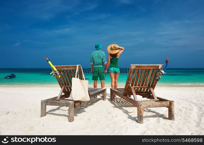 Couple in green on a tropical beach at Maldives