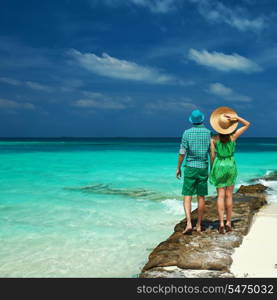 Couple in green on a tropical beach at Maldives