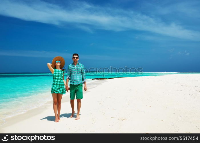 Couple in green on a tropical beach at Maldives