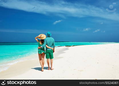 Couple in green on a tropical beach at Maldives