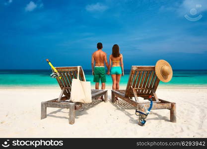 Couple in green on a tropical beach at Maldives