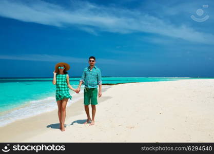 Couple in green on a tropical beach at Maldives