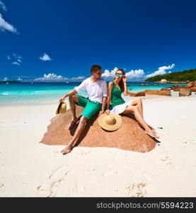 Couple in green on a tropical beach at Seychelles