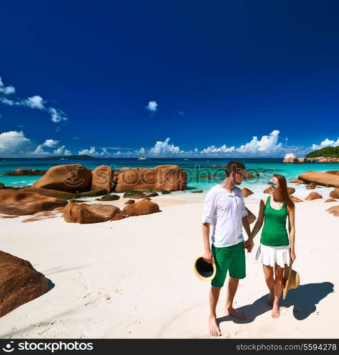 Couple in green on a tropical beach at Seychelles