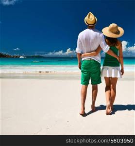 Couple in green on a tropical beach at Seychelles