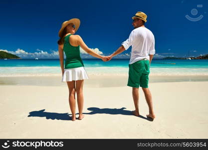 Couple in green on a tropical beach at Seychelles