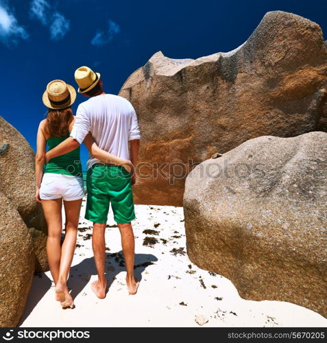 Couple in green on a tropical beach at Seychelles