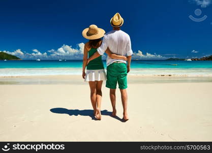 Couple in green on a tropical beach at Seychelles