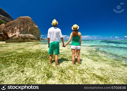 Couple in green on a tropical beach at Seychelles