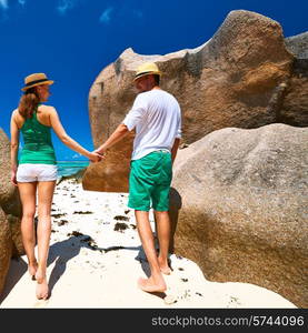 Couple in green on a tropical beach at Seychelles