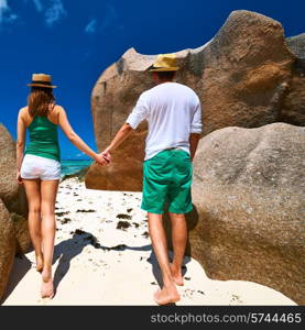 Couple in green on a tropical beach at Seychelles