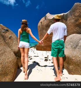 Couple in green on a tropical beach at Seychelles