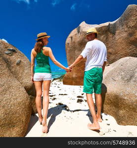 Couple in green on a tropical beach at Seychelles