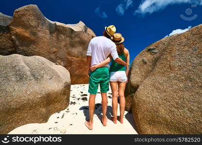 Couple in green on a tropical beach at Seychelles