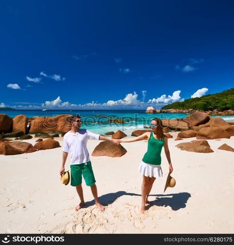 Couple in green on a tropical beach at Seychelles