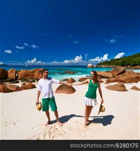 Couple in green on a tropical beach at Seychelles