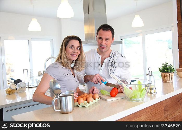 Couple in home kitchen preparing meal