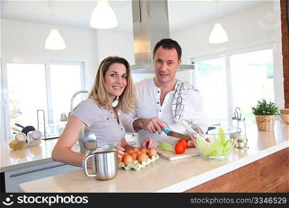 Couple in home kitchen preparing meal