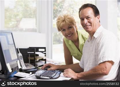 Couple in home office at computer smiling