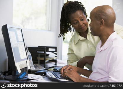 Couple in home office using computer