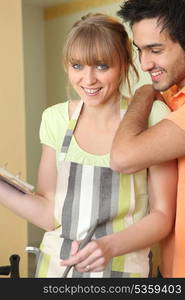 Couple in kitchen cooking