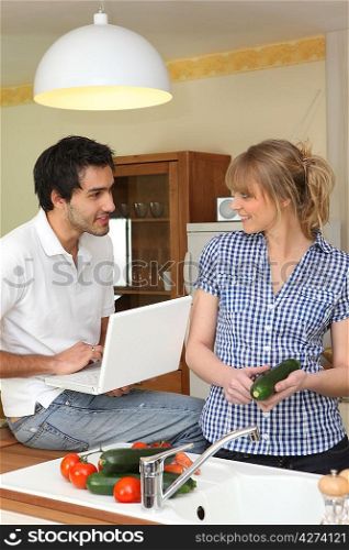 Couple in kitchen with computer