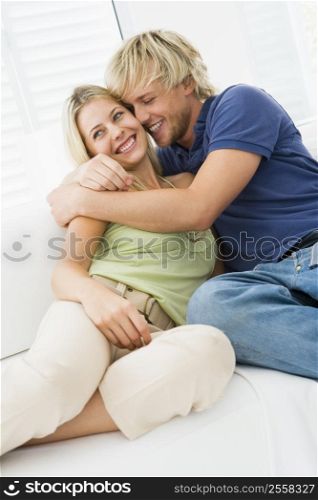 Couple in living room hugging and smiling