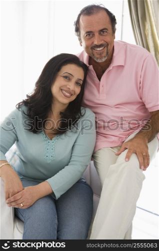 Couple in living room smiling (high key)
